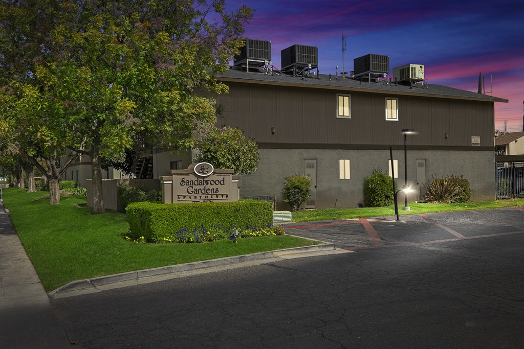 a night view of a building with a sign in front of it