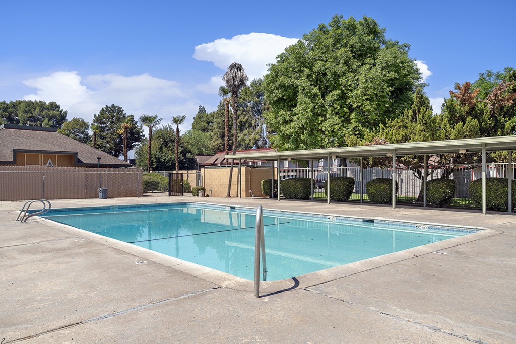 our resort style swimming pool is next to our hotel building with a canopy over it