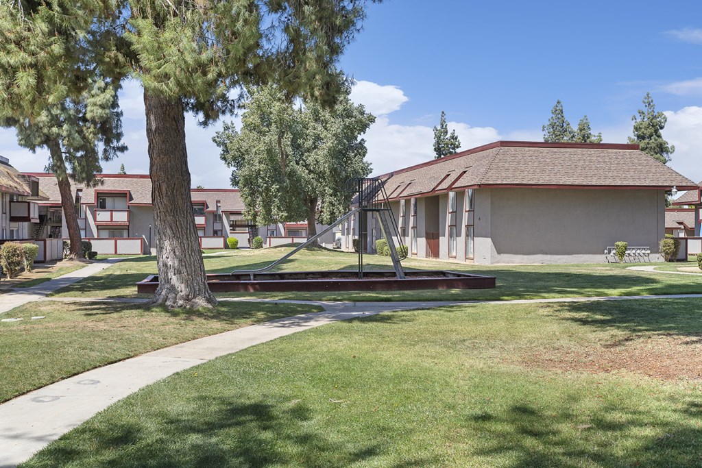 a swing set in a park in front of a building