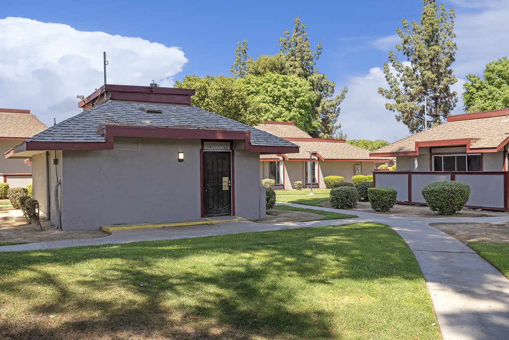 a row of bungalows with trees in the background