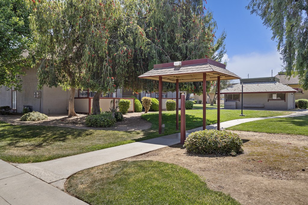 a small park with a picnic area and a pavilion