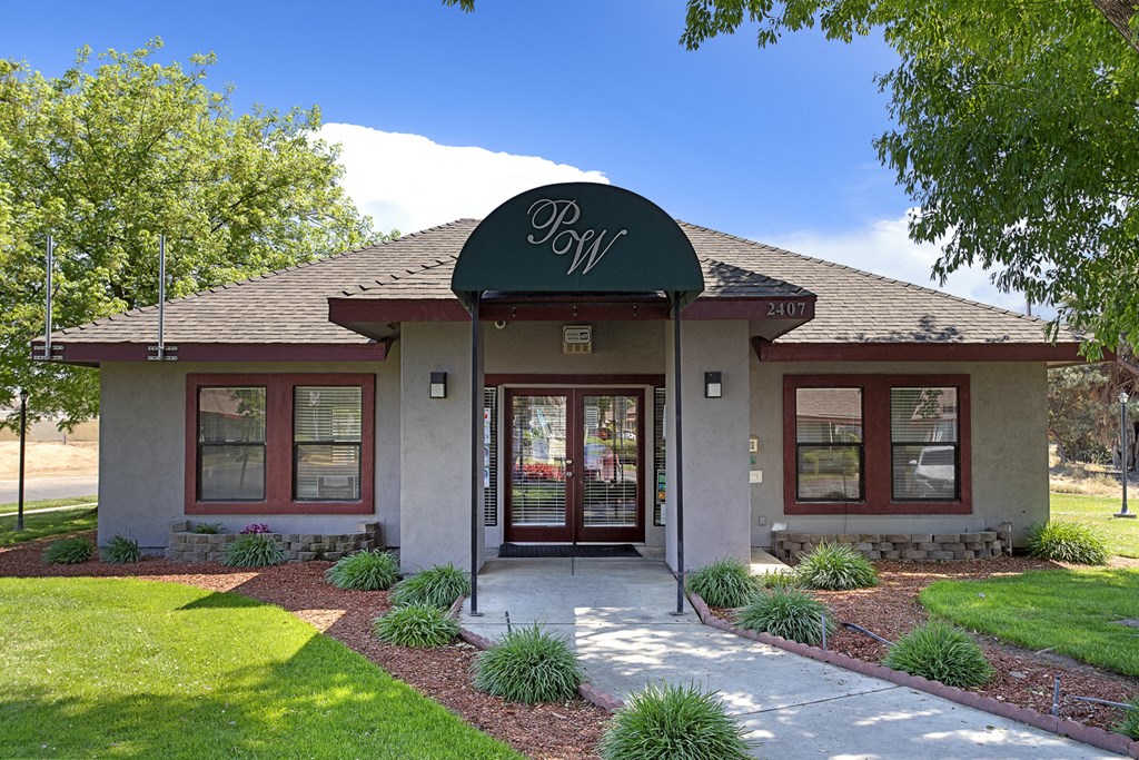 a bungalow with a sign on top of the front of it