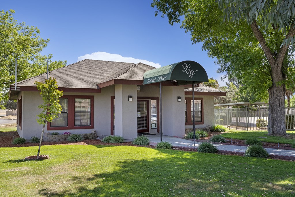 a small building with a green awning on top of it