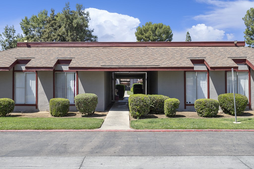 the front of a building with windows and a sidewalk