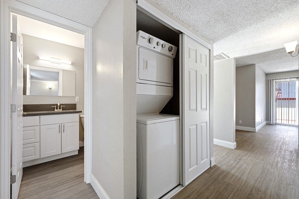 an empty kitchen with a washer and dryer in it