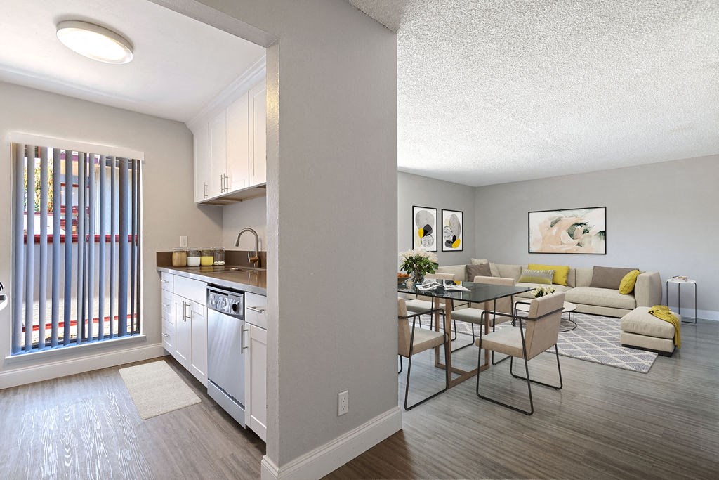 a living room and kitchen with a table and chairs