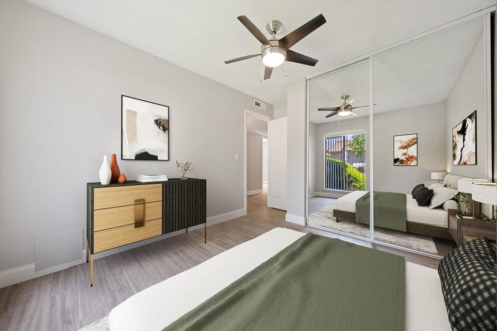 an open living room and bedroom with a ceiling fan