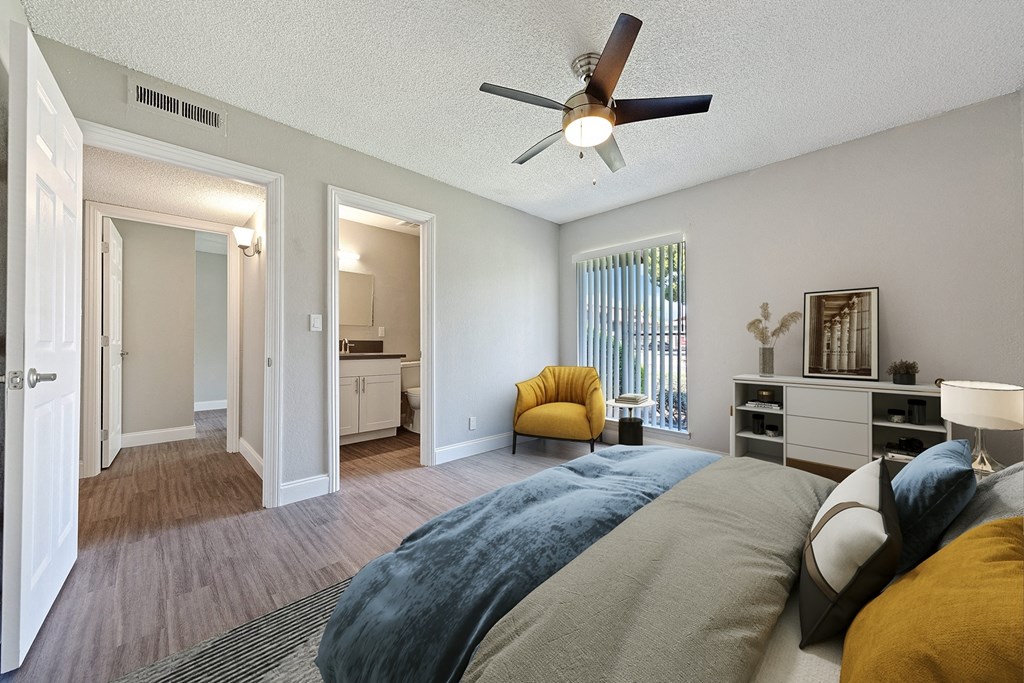 a bedroom with a large bed and a ceiling fan