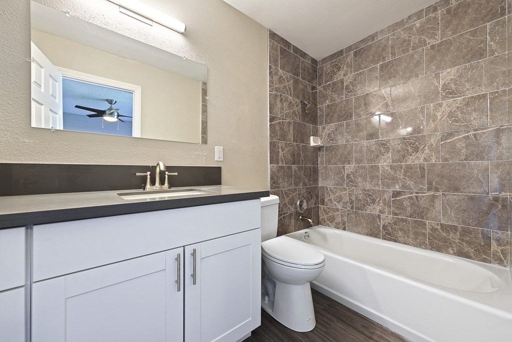 an image of a bathroom with a sink toilet and tub