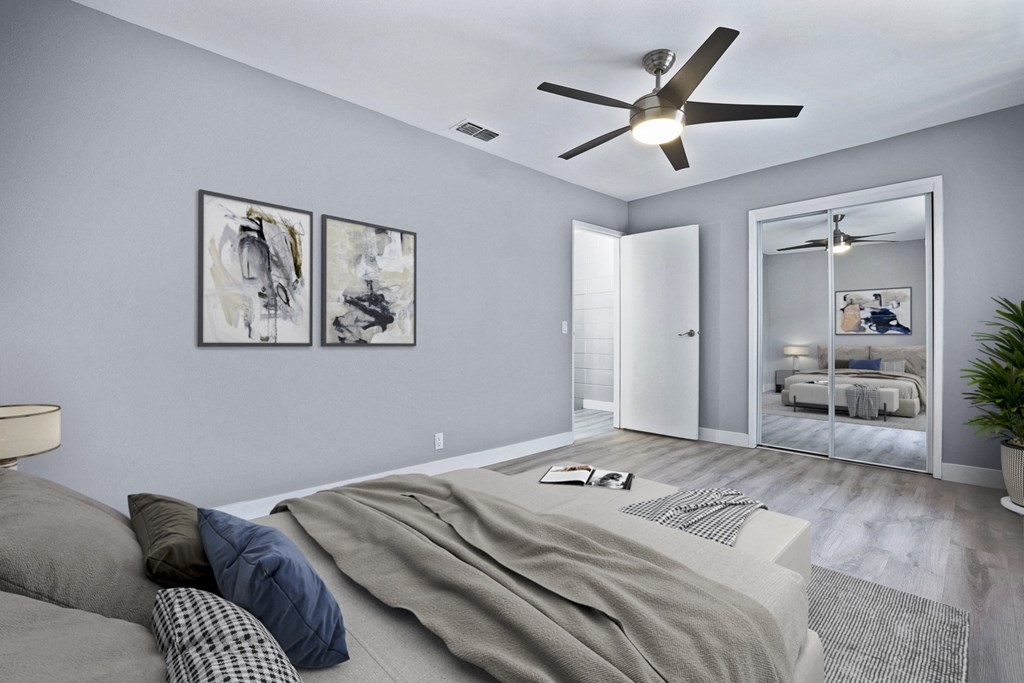 a bedroom with a bed and a ceiling fan