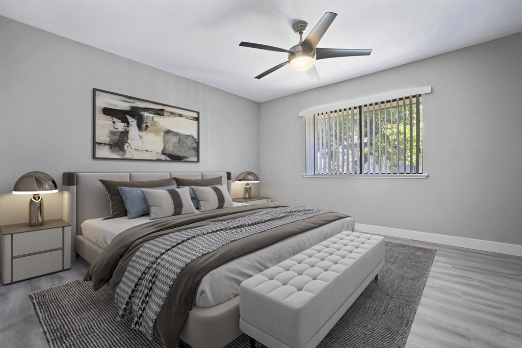 a bedroom with a bed and a ceiling fan