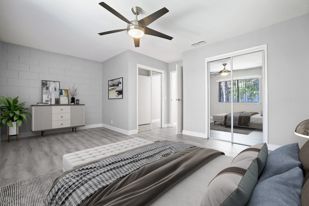 a bedroom with a large bed and a ceiling fan