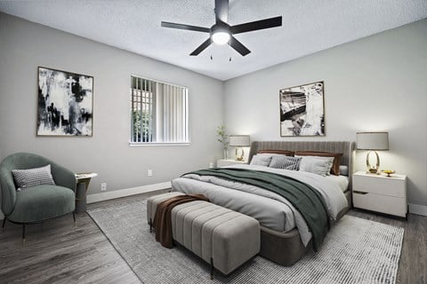 a bedroom with a large bed and a ceiling fan