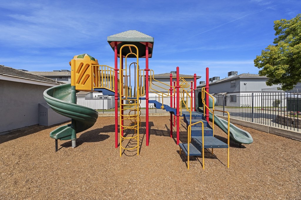 a playground with a slide and climbing equipment