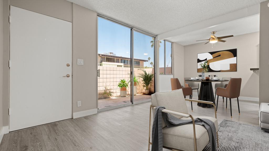 a living room with a sliding glass door leading to a patio