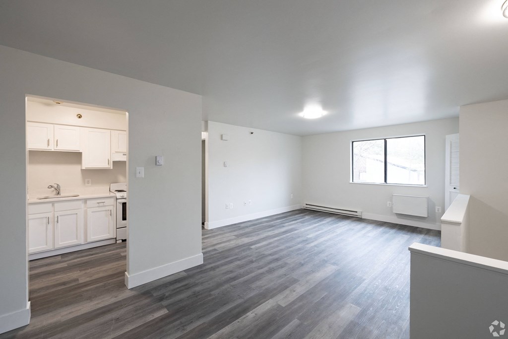 an empty living room and kitchen in a new home