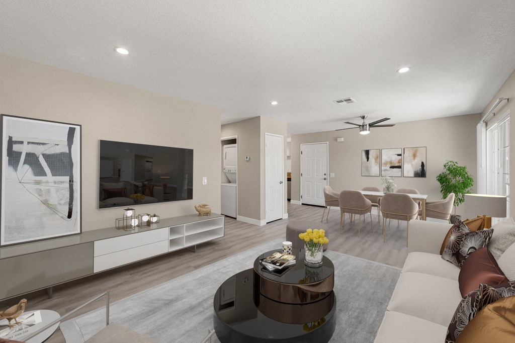 A modern living room with a television, sofas, and a coffee table.