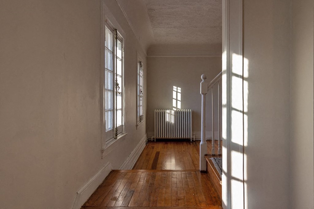the inside of a house with a wood floor and a staircase