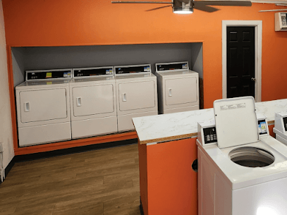 a laundry room with four washes and a dryer in it