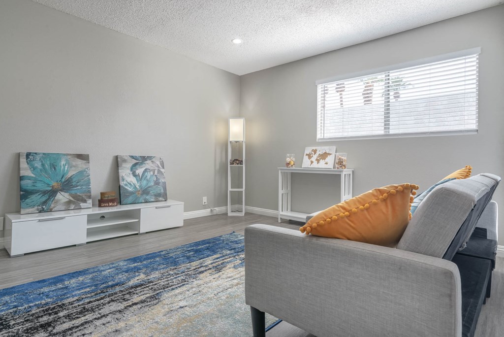 a living room with a couch and a window