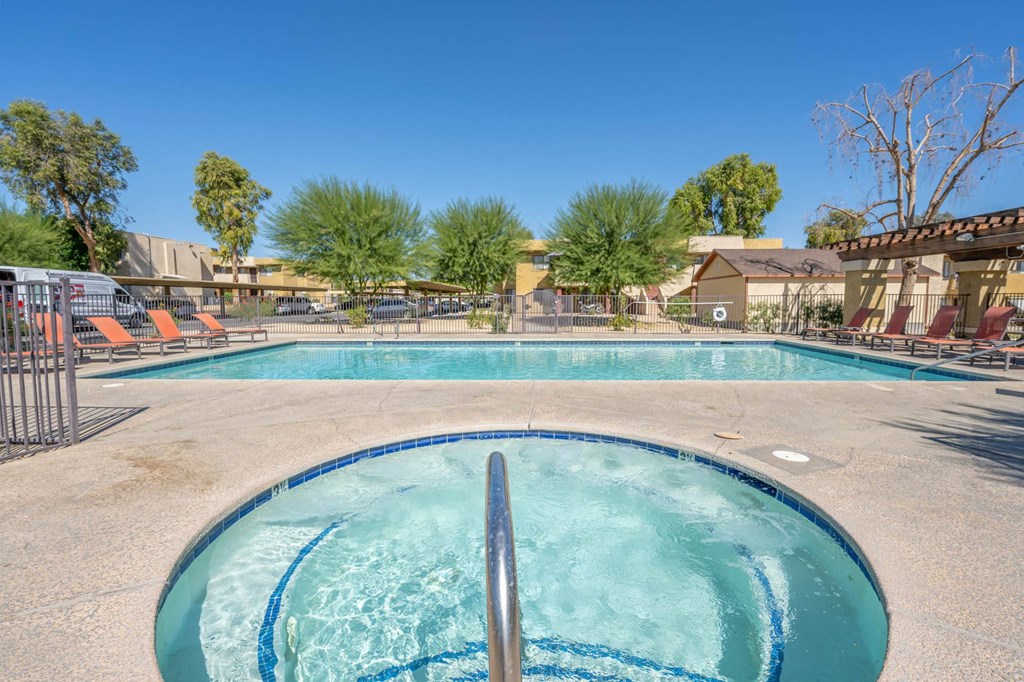 A swimming pool with a metal ladder in the middle of it.