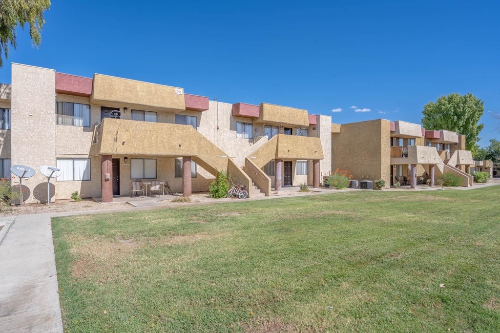 a group of buildings with grass in front of them