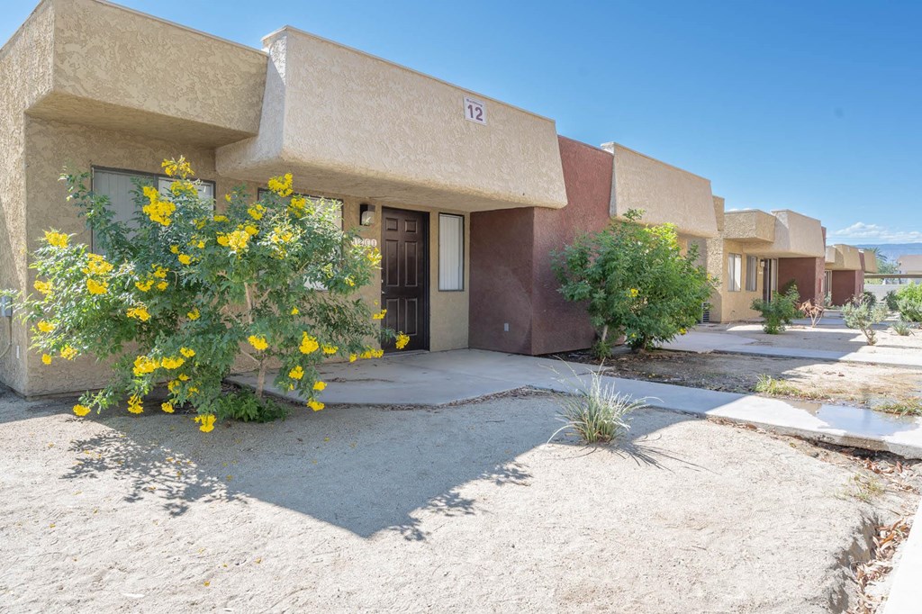 a building with yellow flowers in front of it