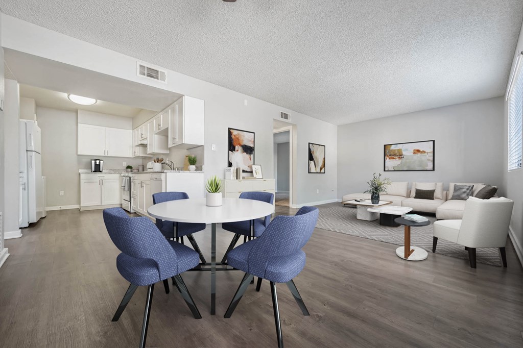 A modern kitchen with a dining table and chairs.