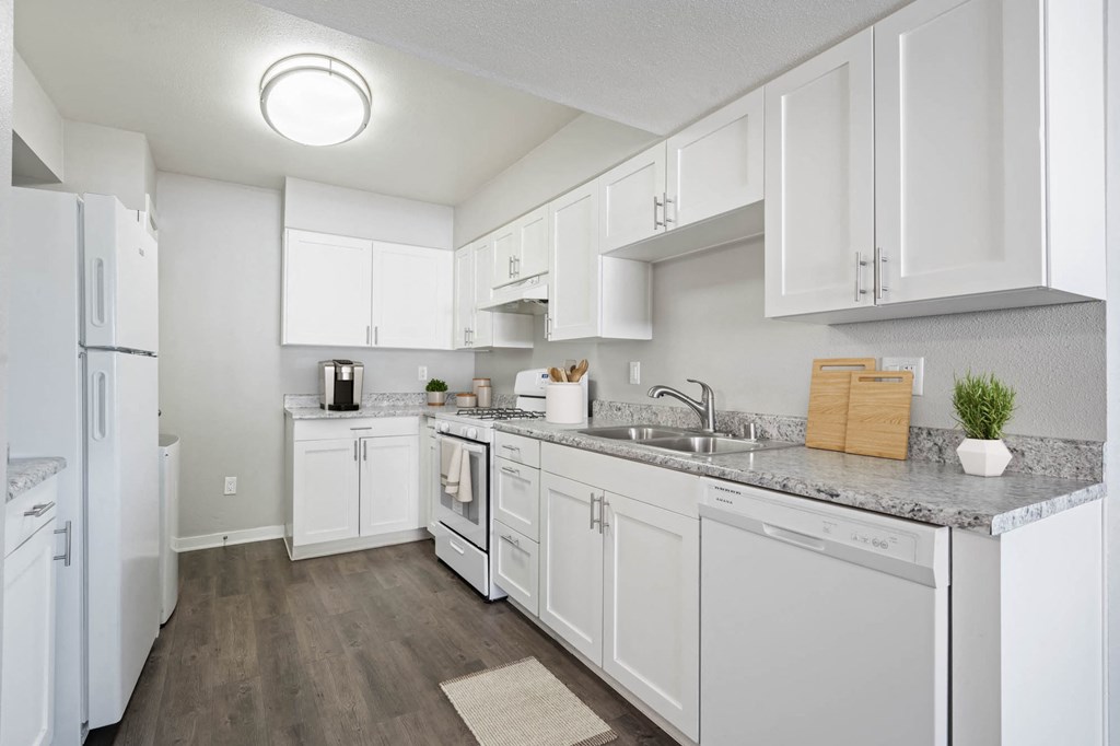 a kitchen with white cabinets and a counter top