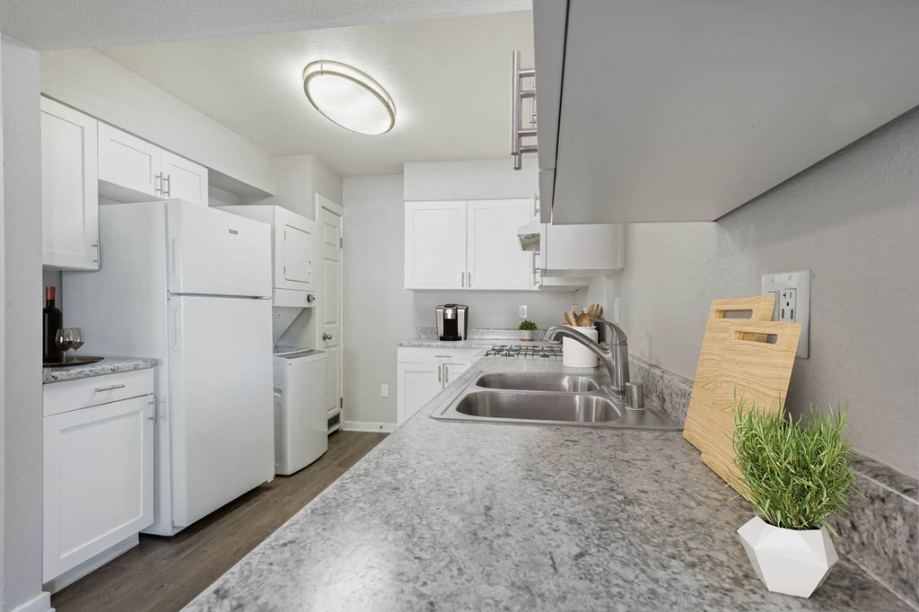 a kitchen with white appliances and a counter top
