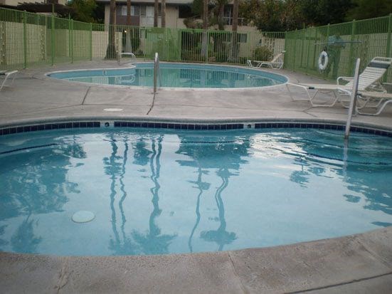 a large pool with a fence around it