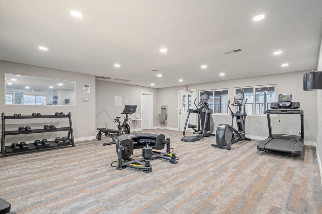 A spacious gym with a variety of exercise equipment.