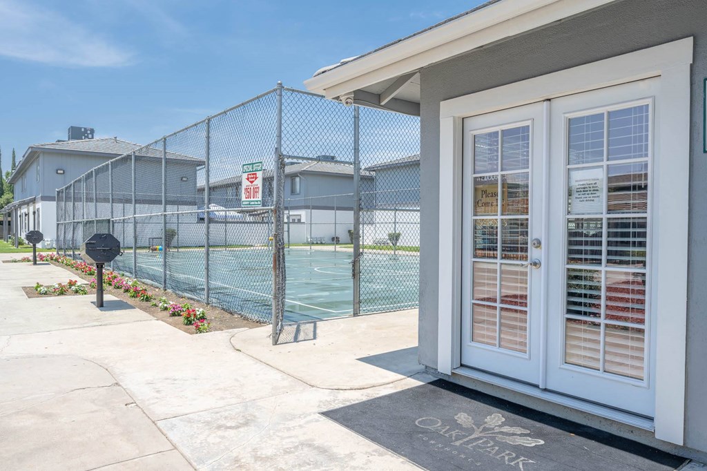 a house with a tennis court in front of it