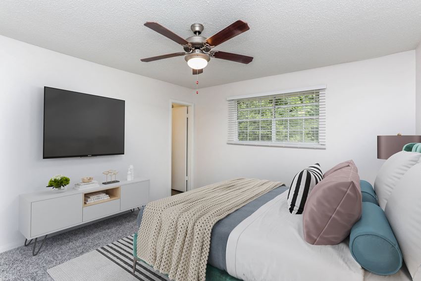 a bedroom with a large bed and a ceiling fan - Photo Gallery