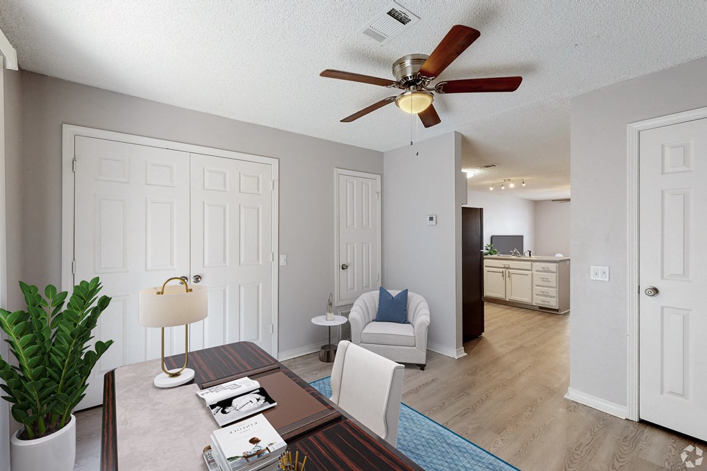 a dining room with a table and chairs and a ceiling fan