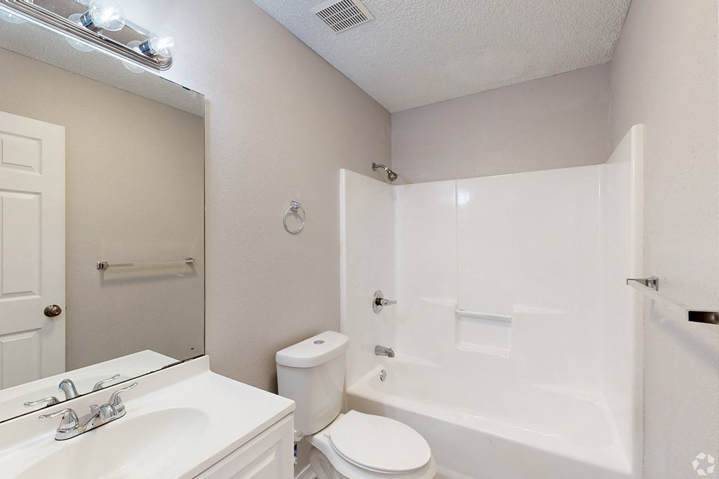 a bathroom with a bathtub and a sink
