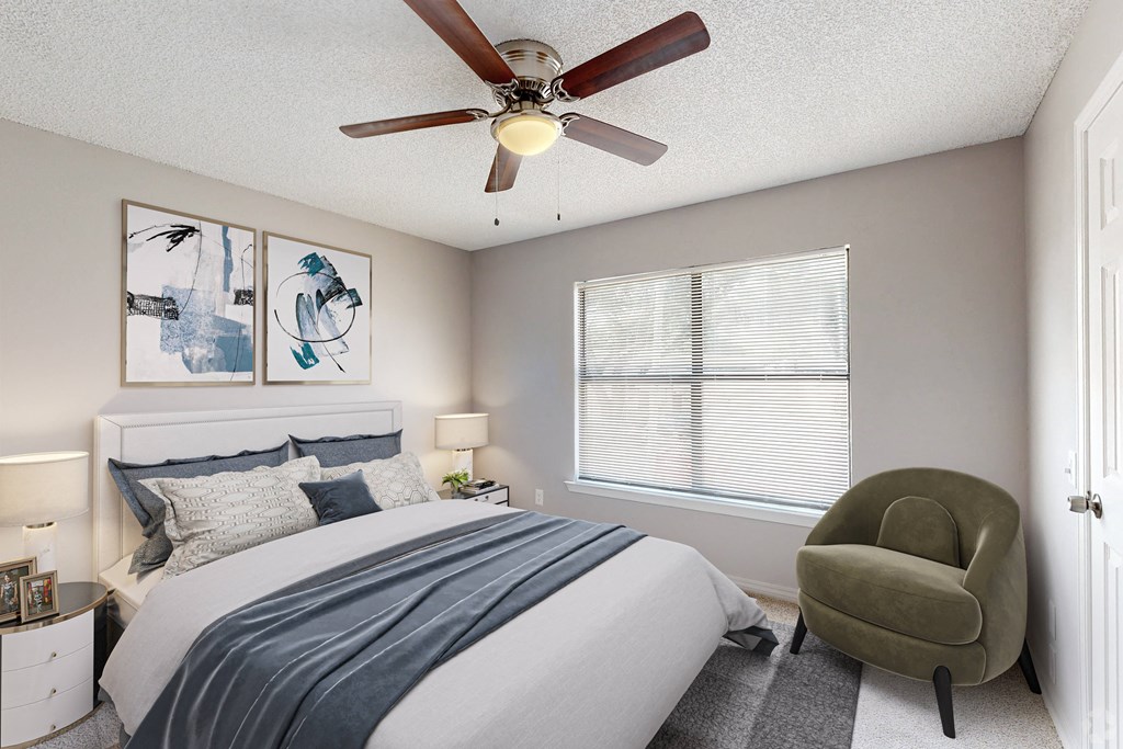 a bedroom with a ceiling fan and a large window