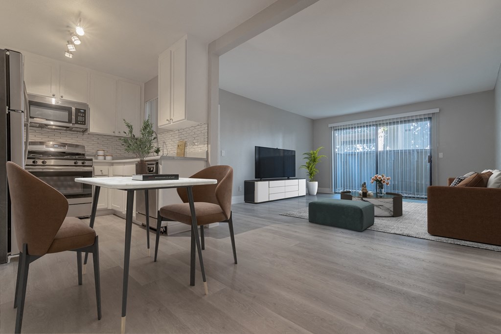 a living room and dining room with a table and chairs