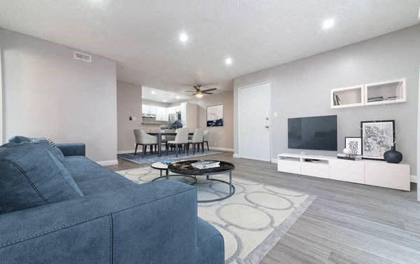 a living room filled with furniture and a flat screen tv