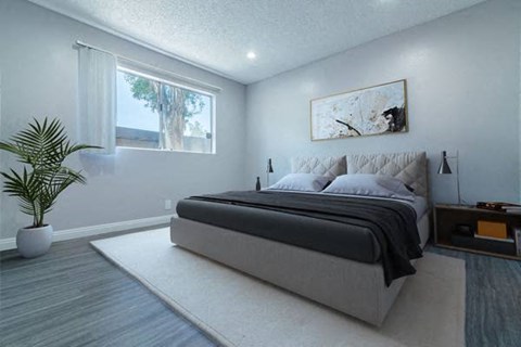 a bedroom with a large bed and a large window