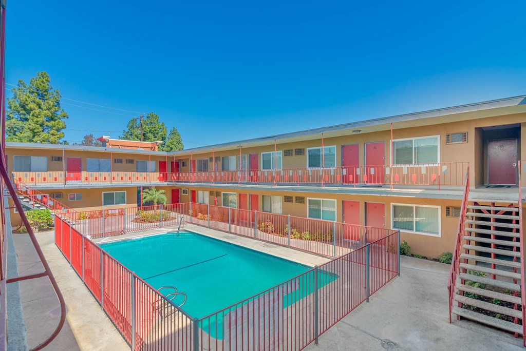 a building with a pool in front of a motel