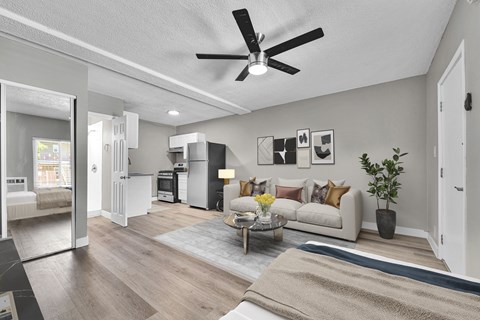 A living room with a white couch and a coffee table.