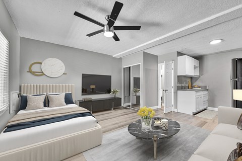 A modern bedroom with a large bed and a ceiling fan.