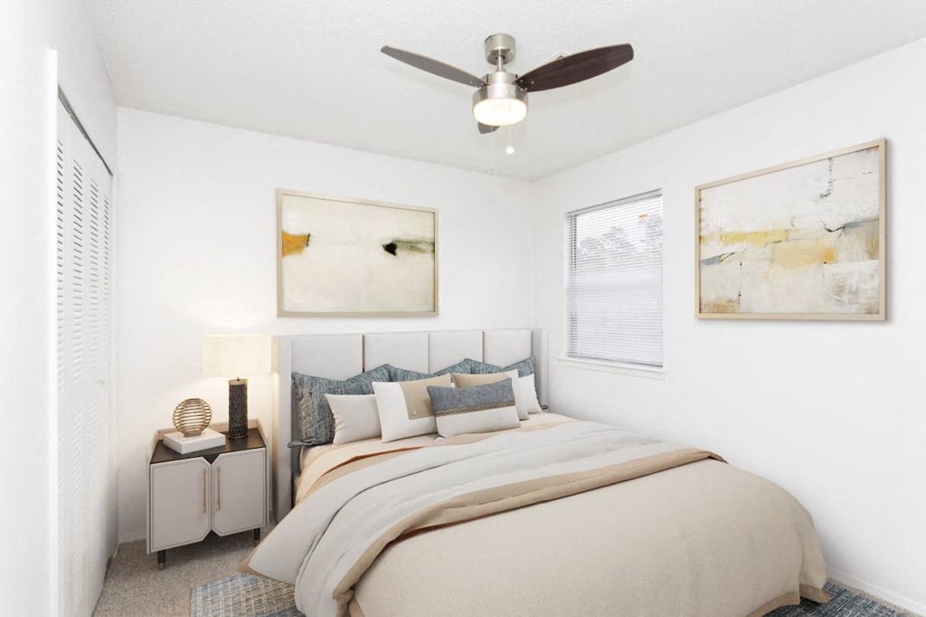 a bedroom with a large bed and a ceiling fan