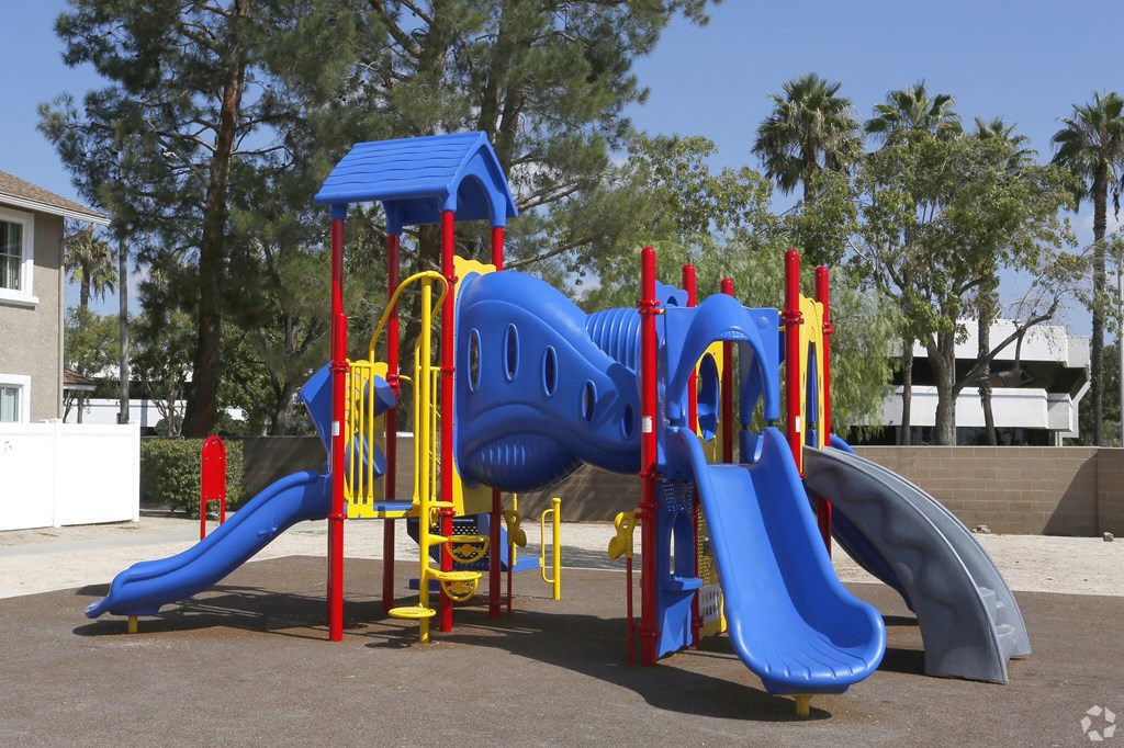 A playground with a slide and a play structure.