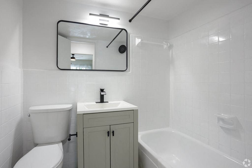 a bathroom with a sink toilet and bathtub