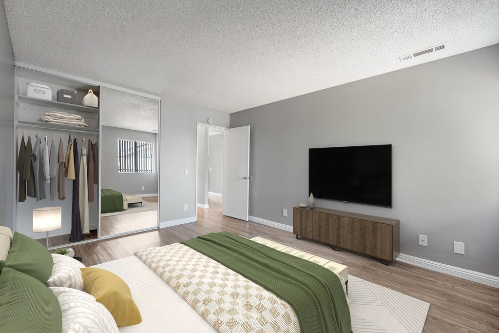 a bedroom with a large bed and a tv