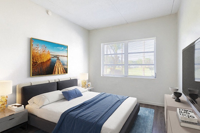 a bedroom with a large bed and a large window