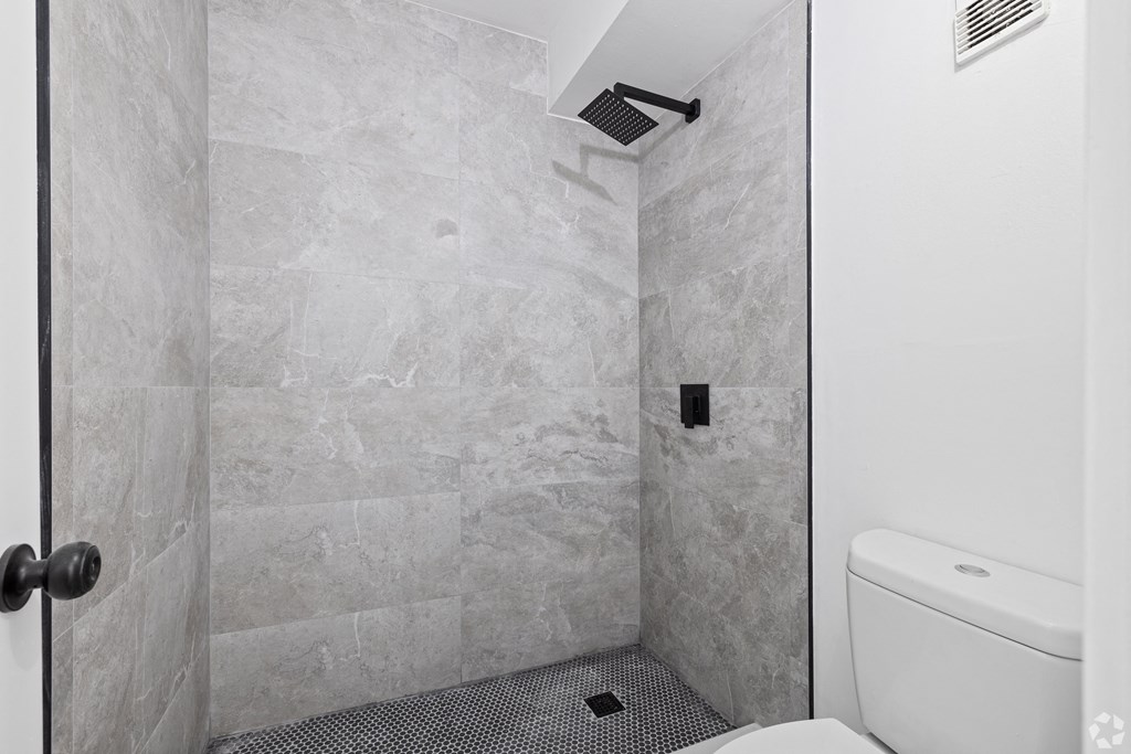 a small bathroom with a toilet and a shower