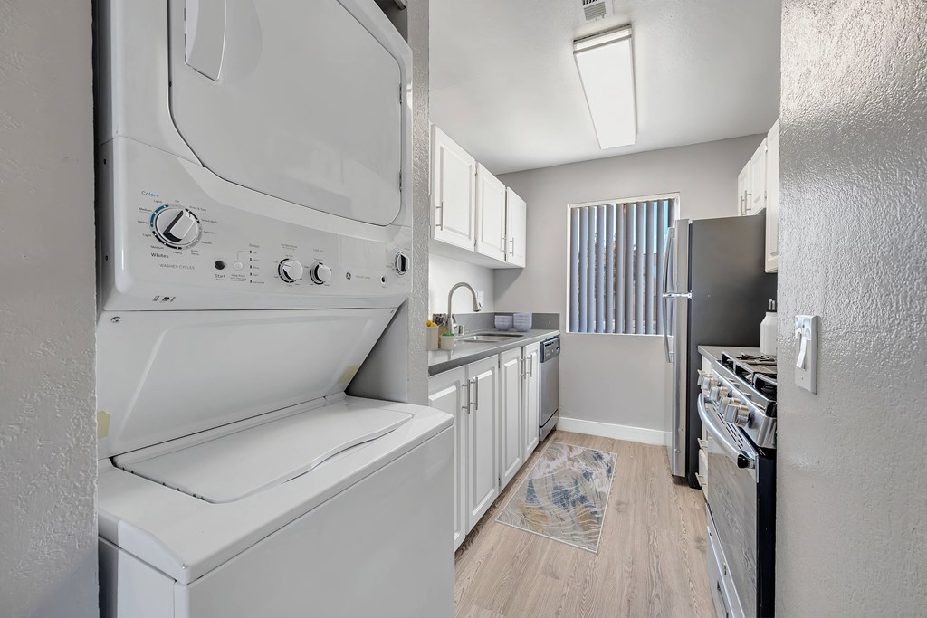 a laundry room with a washer and dryer in a kitchen
